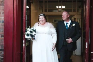 Bride and groom exiting ceremony venue at a Northamptonshire wedding