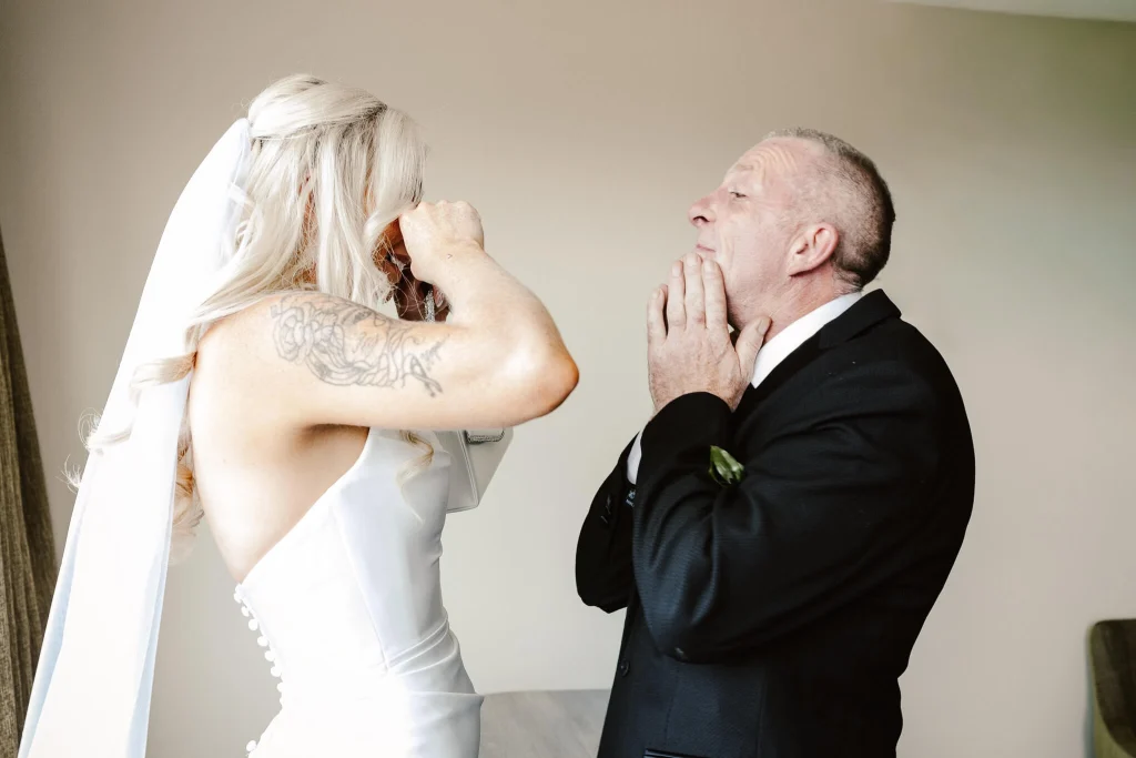 Bride and father share an emotional first look at Hellidon Lakes Hotel & Resort in Northamptonshire.