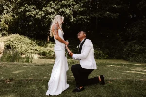 Groom getting down on one knee with his bride at Hellidon Lakes Hotel & Resort