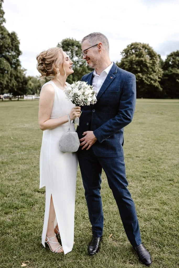 Bride and groom sharing a relaxed moment together at Higgerson Park in Marlow