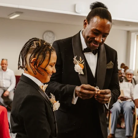 Young ring bearer standing beside the groom as the wedding rings are presented during a civil ceremony at Beaconsfield Registry Office, Buckinghamshire